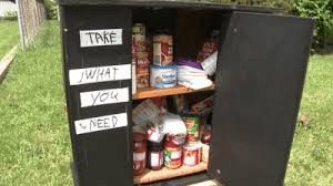 Book with supplies and "Take What You Need " Sign